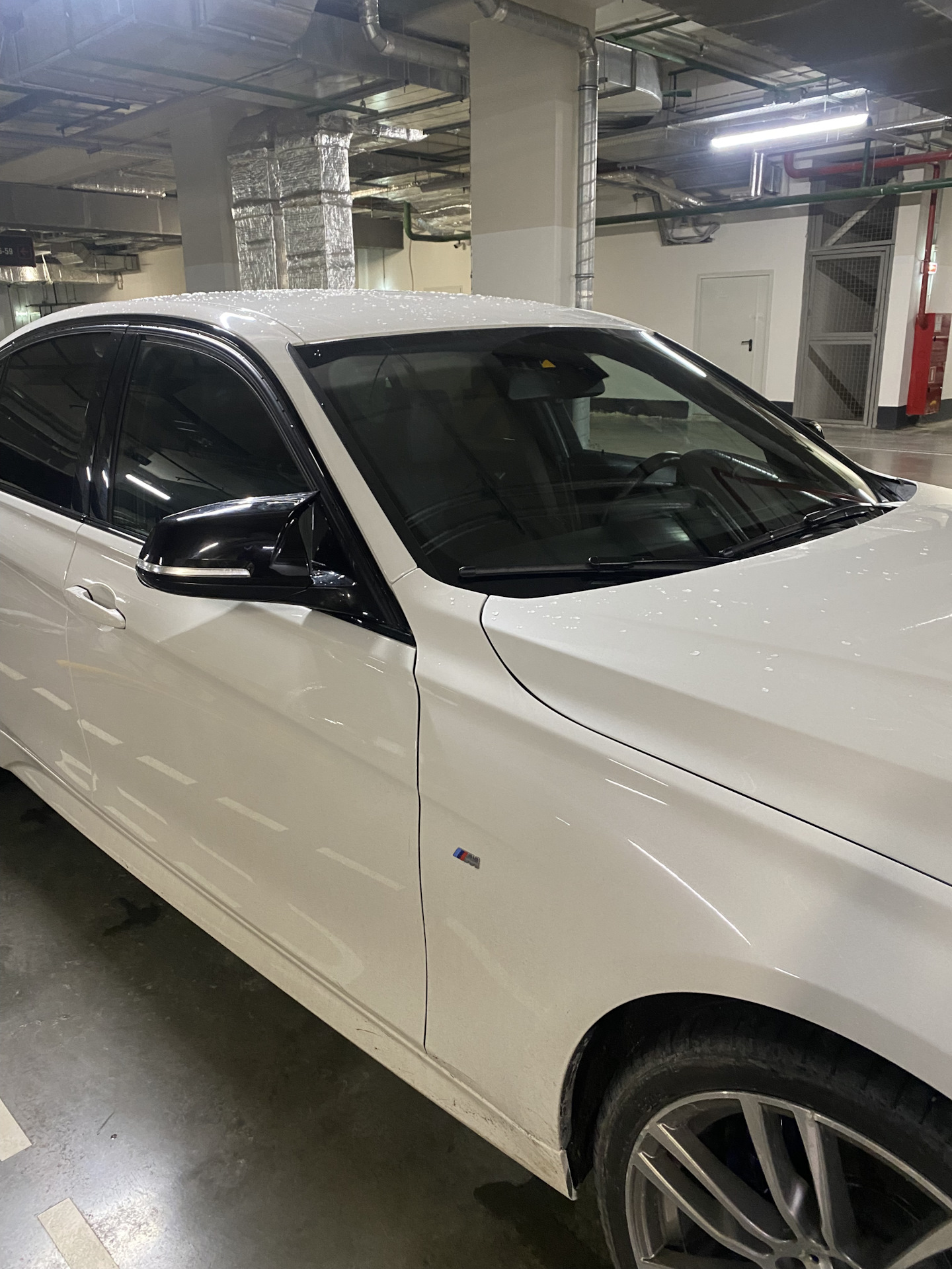 BMW with a replacement black side mirror cover installed